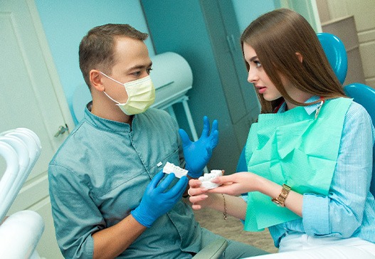 Patient in Warsaw talking to dentist about dental implants