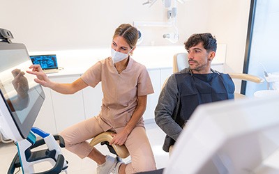 Patient in Warsaw talking to dentist about dental implants