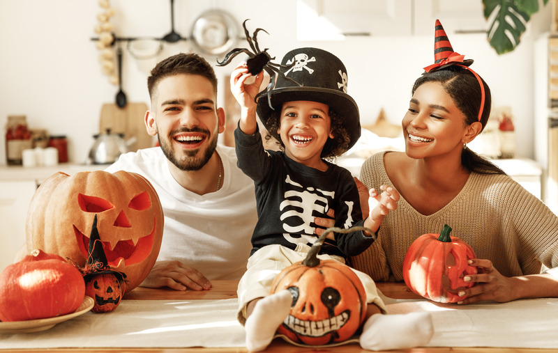 Family smiling on Halloween with no dental emergencies